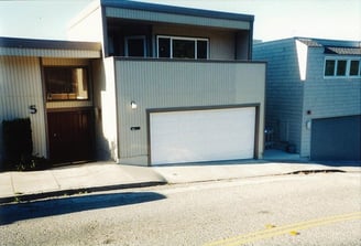 Double wide garage door on a hill with bottom trailer.