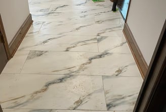 a hallway with a marble floor and a mop