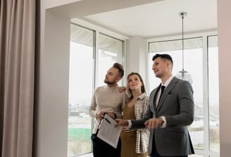 A Realtor in a home with sellers explaining the home selling process 