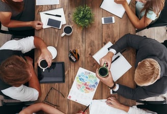 a group of people sitting around a table
