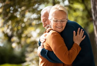 a man and woman are hugging and smiling