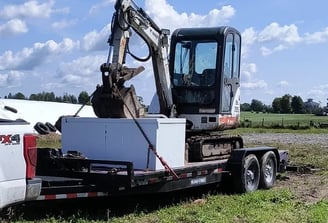 Mini excavator loaded on a trailer