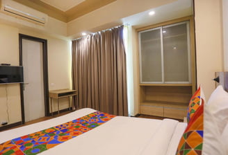 a bed room with a television and a television