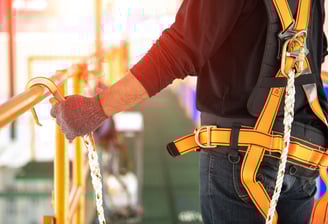 Worker wearing fall protection gear
