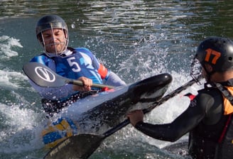 two people are kayaking in the water