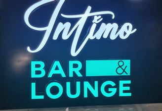 a sign that says, intimo bar and lounge