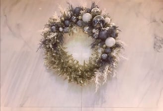 Andy Albright's wreath design hanging on a wall.