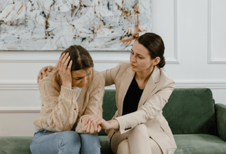 woman supporting another woman through a difficult time