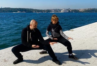 Ismet Himmet and Mine Şilliler practicing Tai Ji stances on the Bosphorus shore in Istanbul.