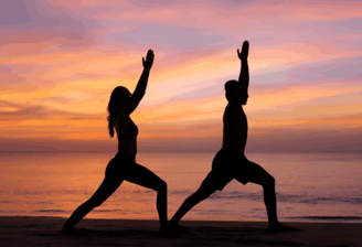 a woman doing yoga exercises on the beach