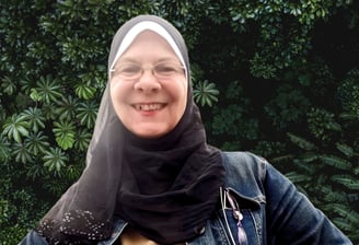 a woman wearing a hijab and smiling