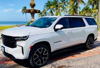 a white suv parked in front of a fountain