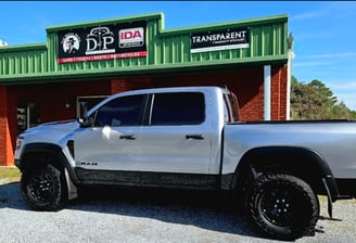 A truck, tinted in front of D and P auto detailing