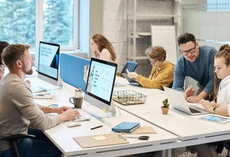 property managers sitting at a table with computers working hard for clients