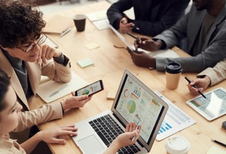 property managers working together at a table in front of computers