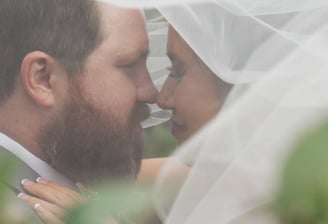 Bride and groom under a veil