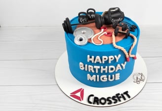 a cake with a gym themed cake topper