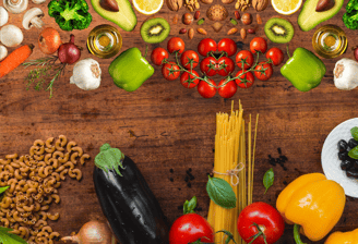 a variety of vegetables and fruits on a wooden table