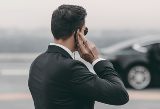 a man in a suit and tie is talking on the phone