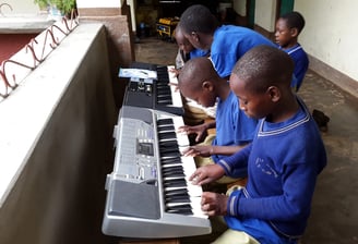 Tanzanian villange children are learning music on keyboards