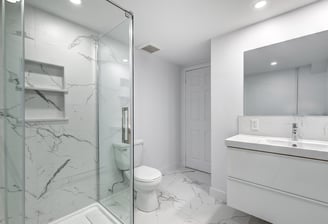 Luxury glass shower with marble tile and modern vanity in bathroom renovation in London, Ontario.