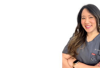 a woman in a grey scrubs with an inviting smile