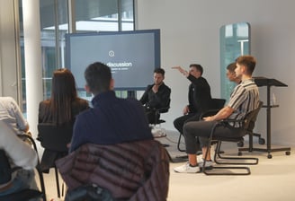 a group of people sitting in chairs in a room