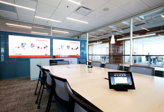 Image of a conference room with control touch panel