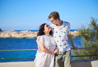 couple posant yeux dans les yeux avec la méditerranée en arrière-plan, cadre naturel et lumineux