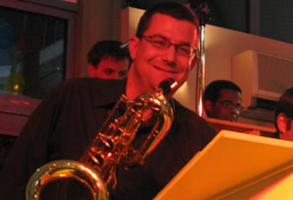 a man playing a saxophone and a saxophone