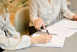 Two women sitting in a consulting and having in conversation in nutritional advice.