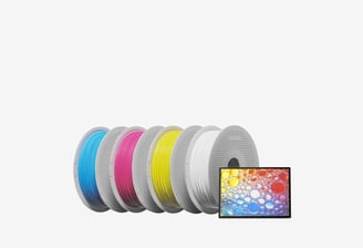a group of four different colored spoolies for 3d printing