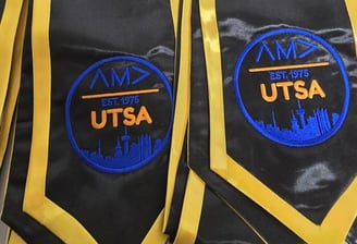 Custom black and gold graduation stoles with AMA UTSA logo embroidery – personalized academic stoles