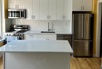 a kitchen with a stainless steel refrigerator and a refrigerator