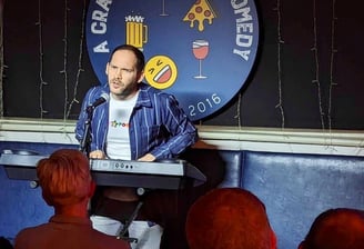 Alex Duffy doing stand-up comedy with keyboard in Tadcaster