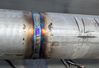 a metal pipe pipe with a blue flame on it