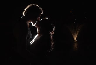 Bride and groom kissing in the dark