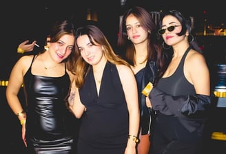 a group of women in black dresses standing in a row