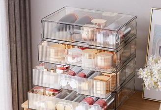 a stack of three clear plastic containers with cupcakes