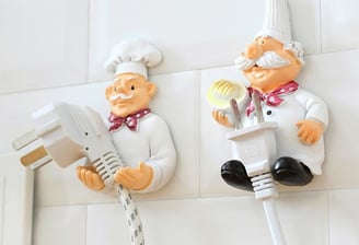 a couple of figurines of chefs and a plugged in a plugged