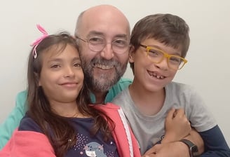 a man and two children posing for a picture