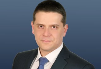 a man in a suit and tie with a blue tie