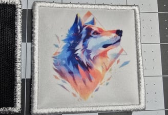 Colorful sublimated patch featuring a geometric watercolor-style wolf head design with embroidered w