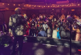 LuxeBand singer performing on stage at a historic venue