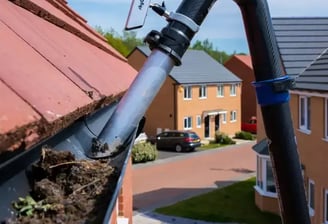 leaves being removed from gutter in worcestershire