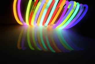 a group of neon - colored bracelets with neon lights