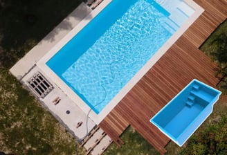 a pool with a wooden deck and a pool