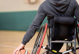 Child with muscular dystrophy receiving physiotherapy for strength and mobility.