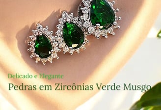 a pair of emerald green earrings with diamonds