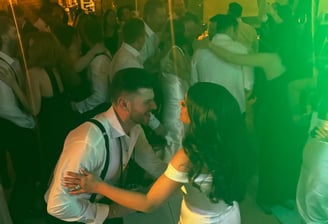 Bride and groom dancing to LuxeBand at their wedding with guests on the dance floor